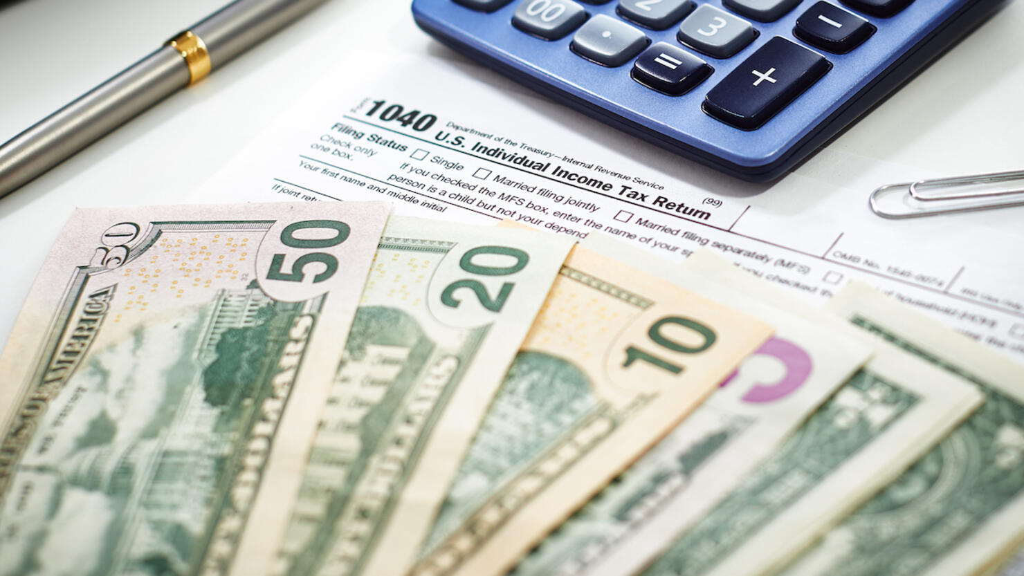 US Currency with calculator and Tax Form