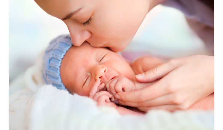 Mother kissing baby