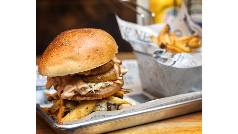 Huge Hamburger in Platter with Onion Rings and French Fries
