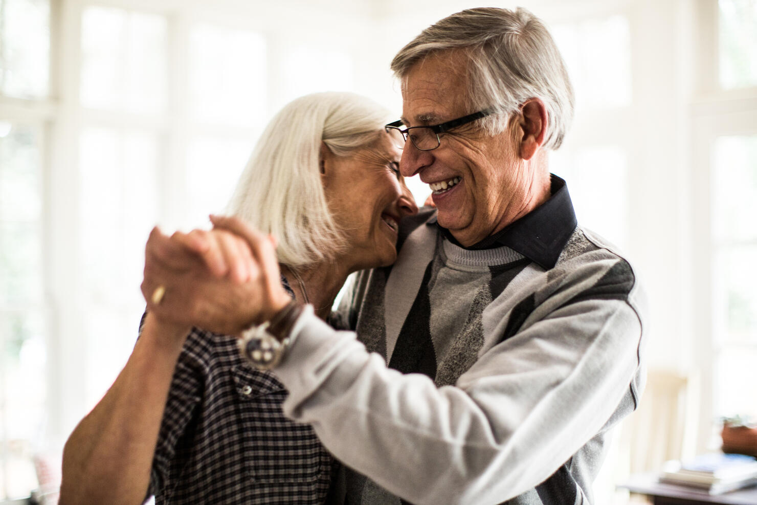 Senior couple dancing in living room