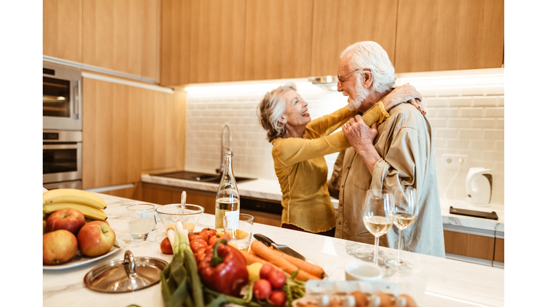 senior couple dancing in the kitchen