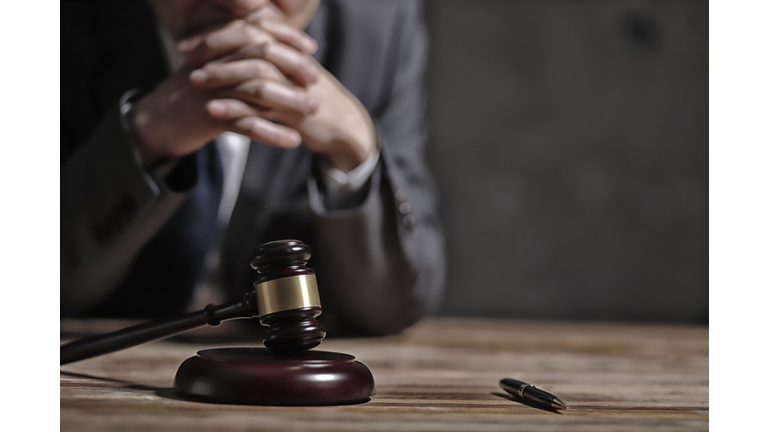 Close-Up Of Lawyer Sitting At Table