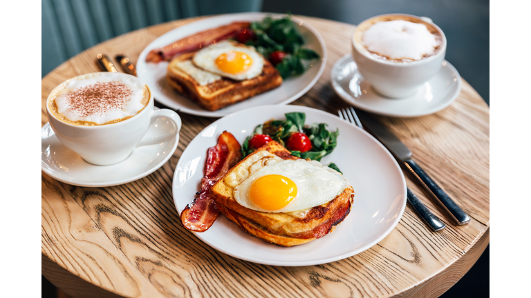 Croque Madame sandwich with bacon served for breakfast in a restaurant, side view