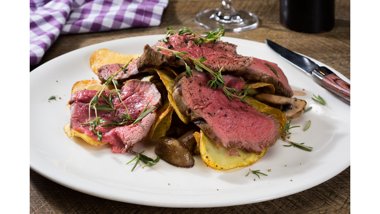 Chateaubriand steak with potatoe chips and mushrooms
