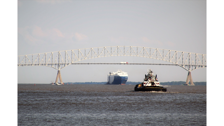 Small Tugboat and Large Automobile Cargo Ship