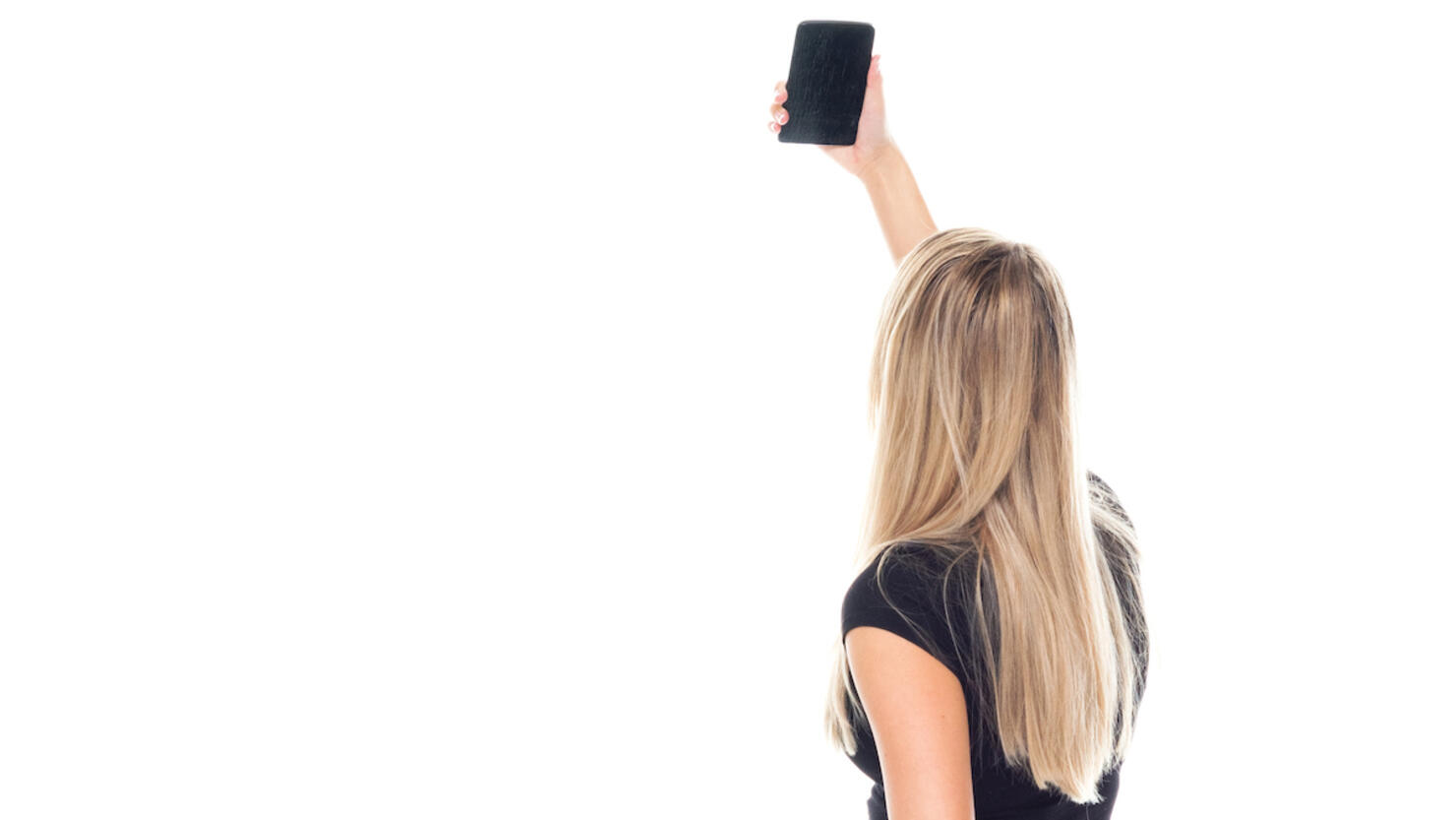 Caucasian young women photography resting in front of white background wearing businesswear and using mobile phone