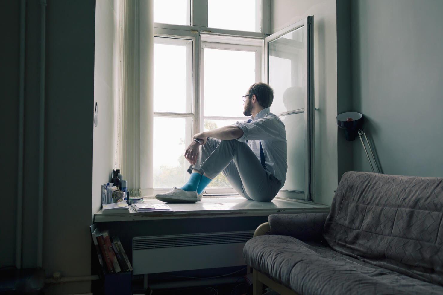 Man sitting on window sill