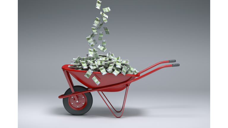 Euros falling into red wheelbarrow