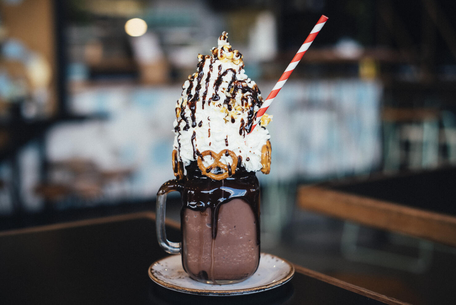 Chocolate mega milkshake topped with cream, served in a mason jar