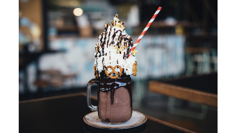 Chocolate mega milkshake topped with cream, served in a mason jar