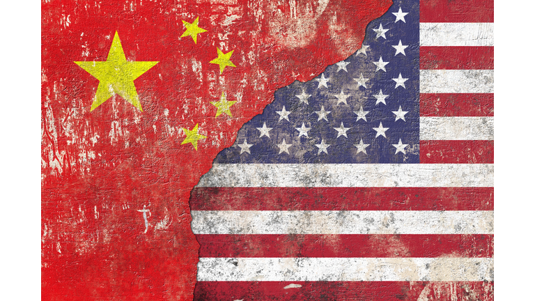 Chinese and USA flag on textured wall background