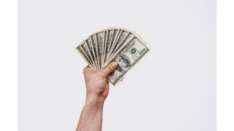 Man's hand holds american dollars money. Finance, earnings, crediting