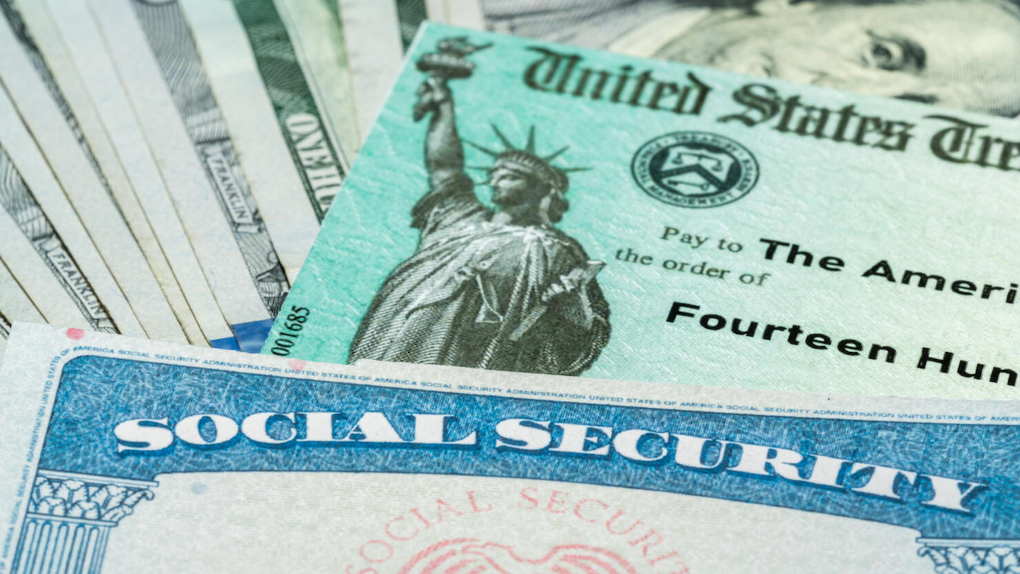 Illustration of the 2021 federal stimulus check from the IRS with cash and social security card
