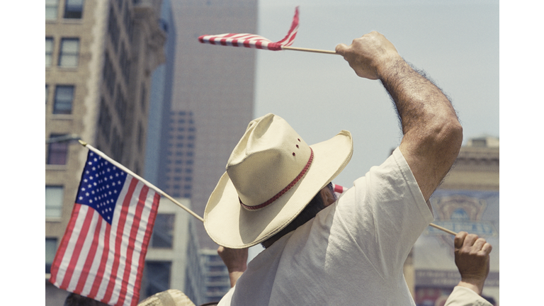 Man waving US flag during Immigration Bill Rally in Los Angeles