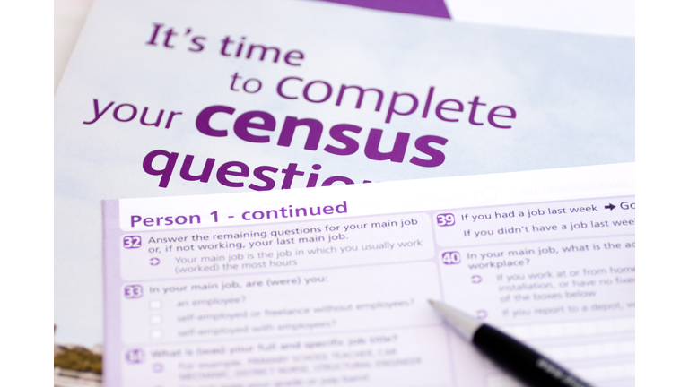 Pen over purple and white census forms