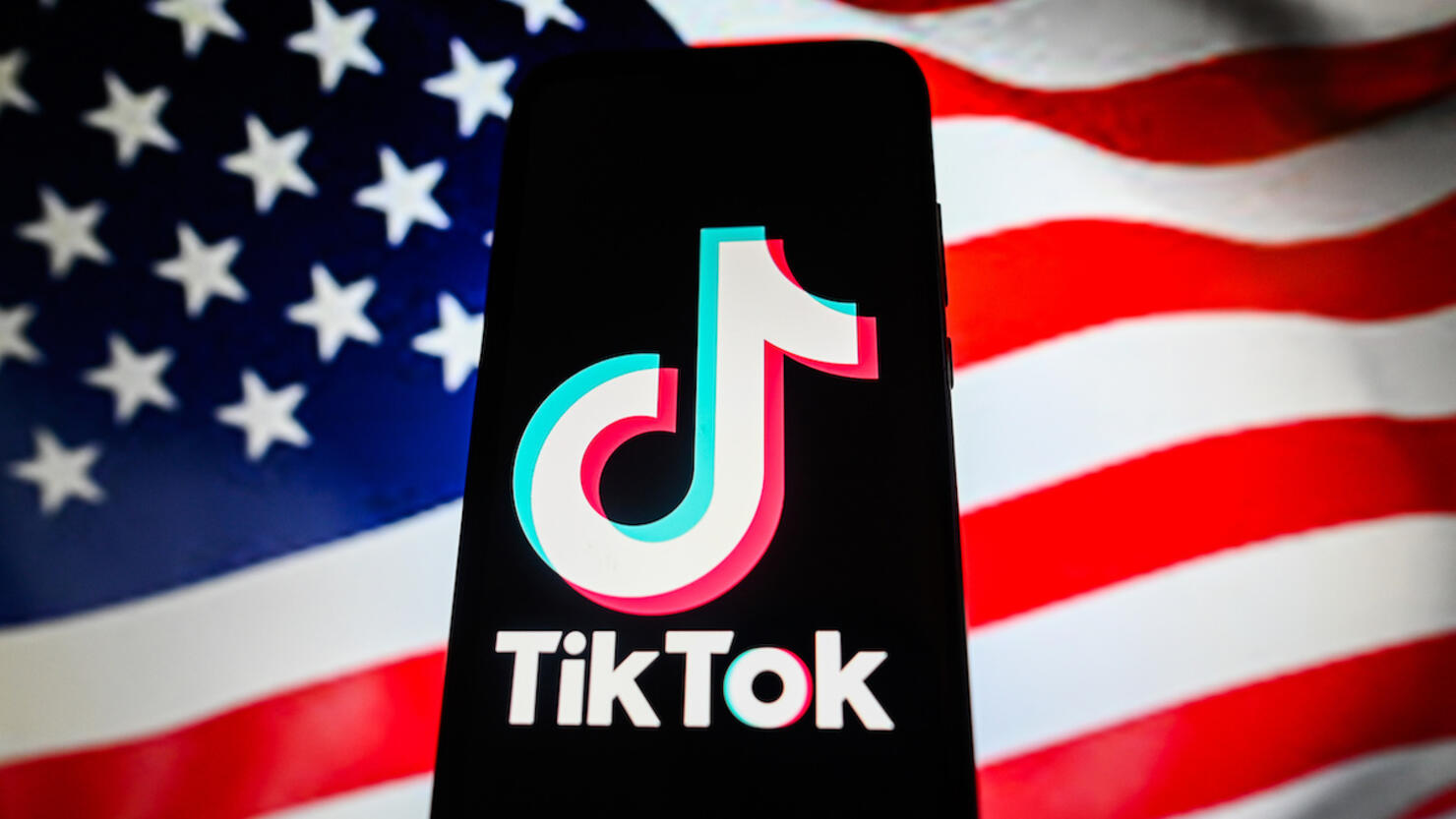 In this photo illustration a TikTok logo is displayed on a