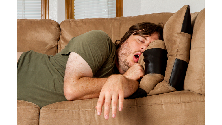 Man taking a quick nap on the couch