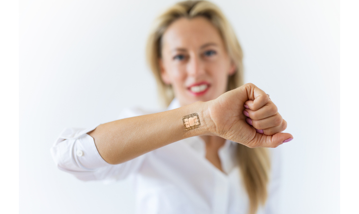 Woman with computer chip implant in hand