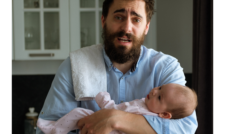 Father in his arms holds his little child