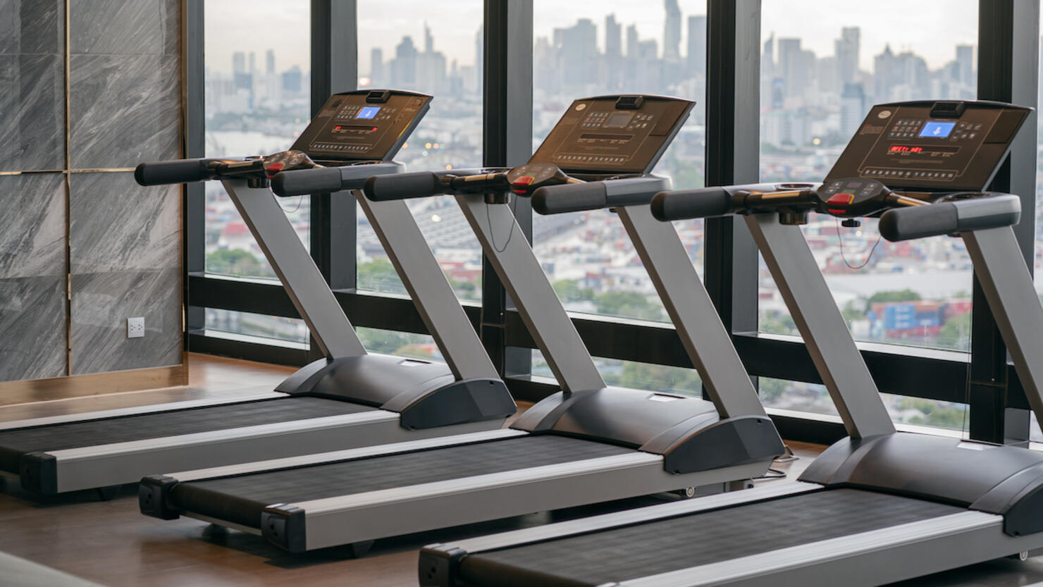 treadmill located inside a gym on a high-rise condominium building.