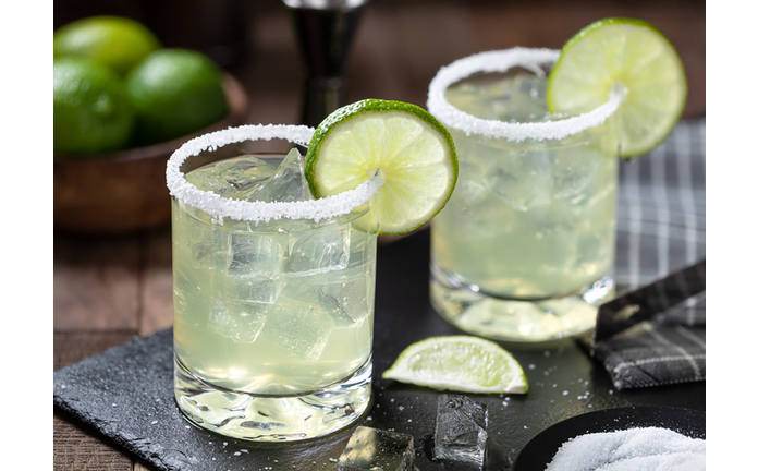 Margarita cocktail with ice, lime and salt riim