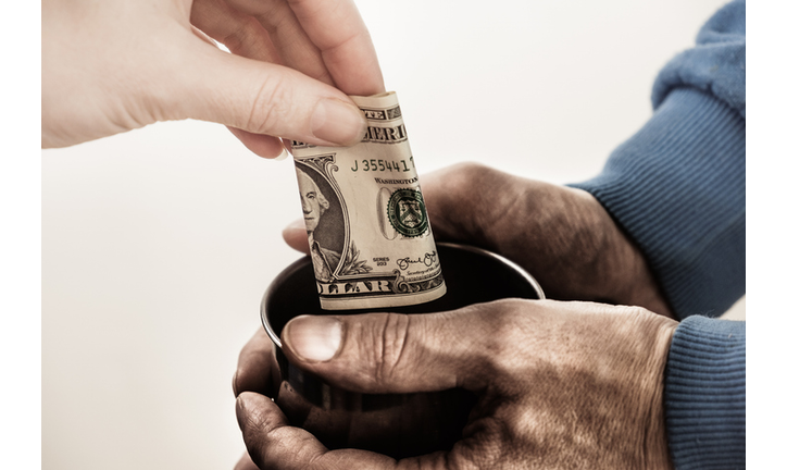 Close-up hands with cup Dirty hands of a beggar homeless man and a dollar bill of alms.