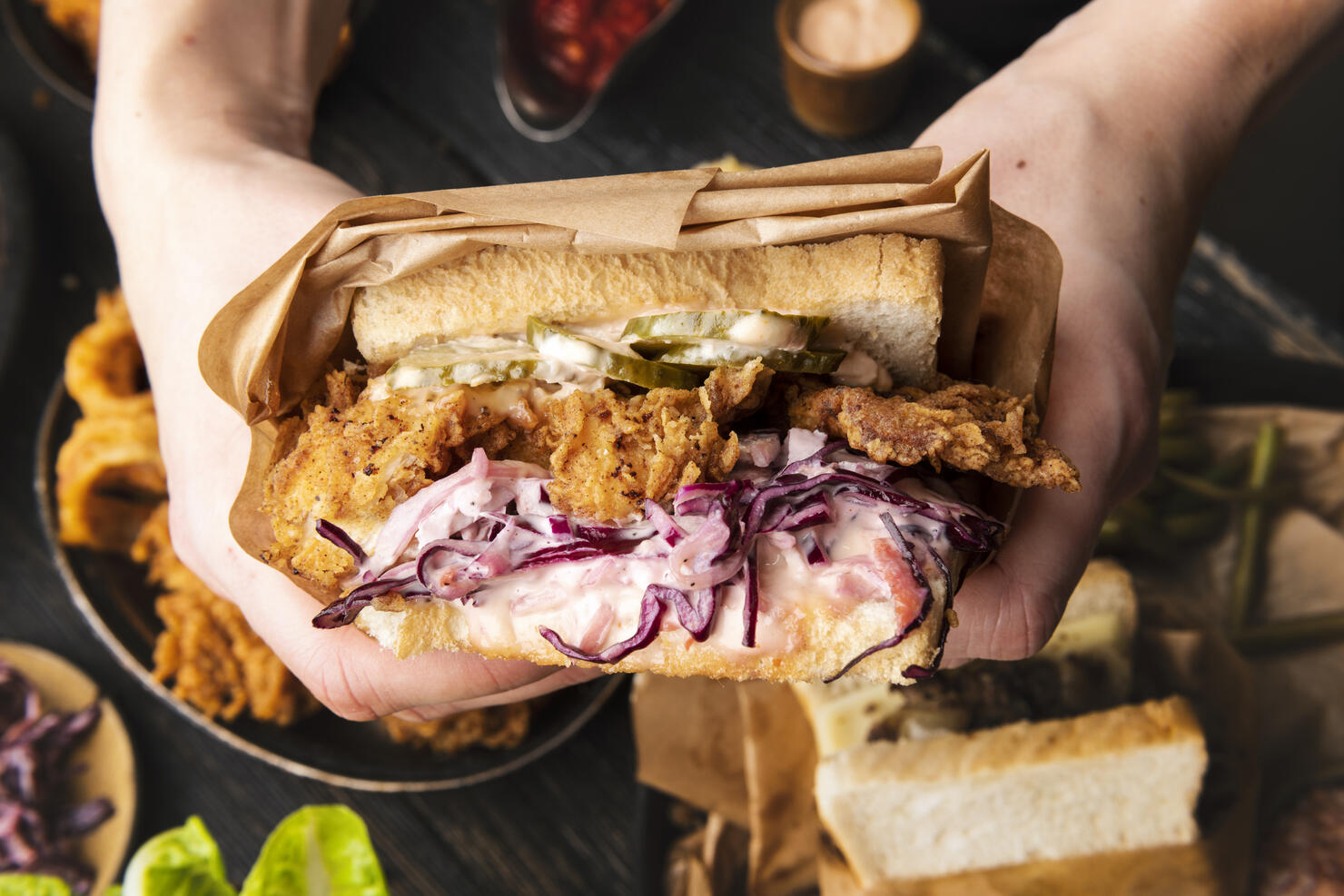 Woman is holding tasty sandwich before eating