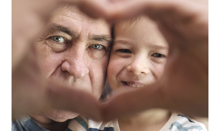 Grandfather and Grandson Making a Heart Shape Hand Gesture Together, Looking at Camera. Happy Old Man Grandpa and Little Boy Grandchild Togetherness. Two Generations Relations. Family Love Concept.