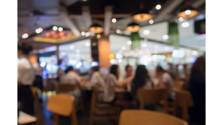 People in restaurant cafe interior with bokeh light blurred customer abstract background