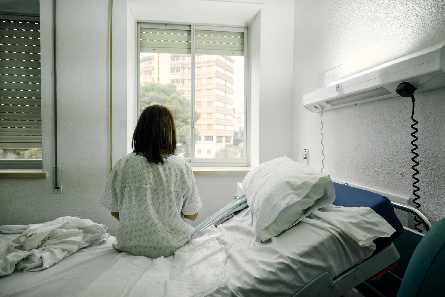 sick woman alone in a hospital room