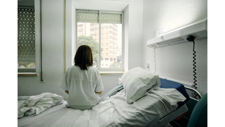 sick woman alone in a hospital room
