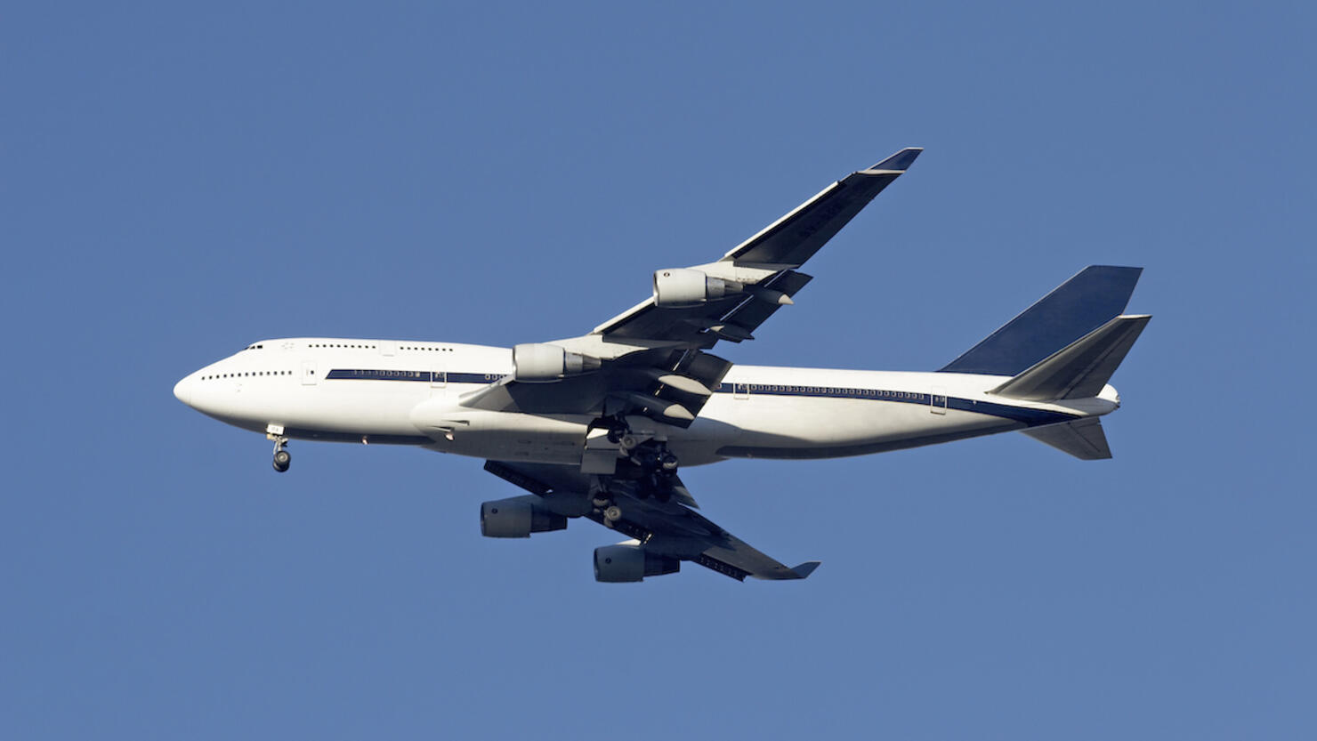 Boeing 747 Jumbo Jet in air, side view, low angle