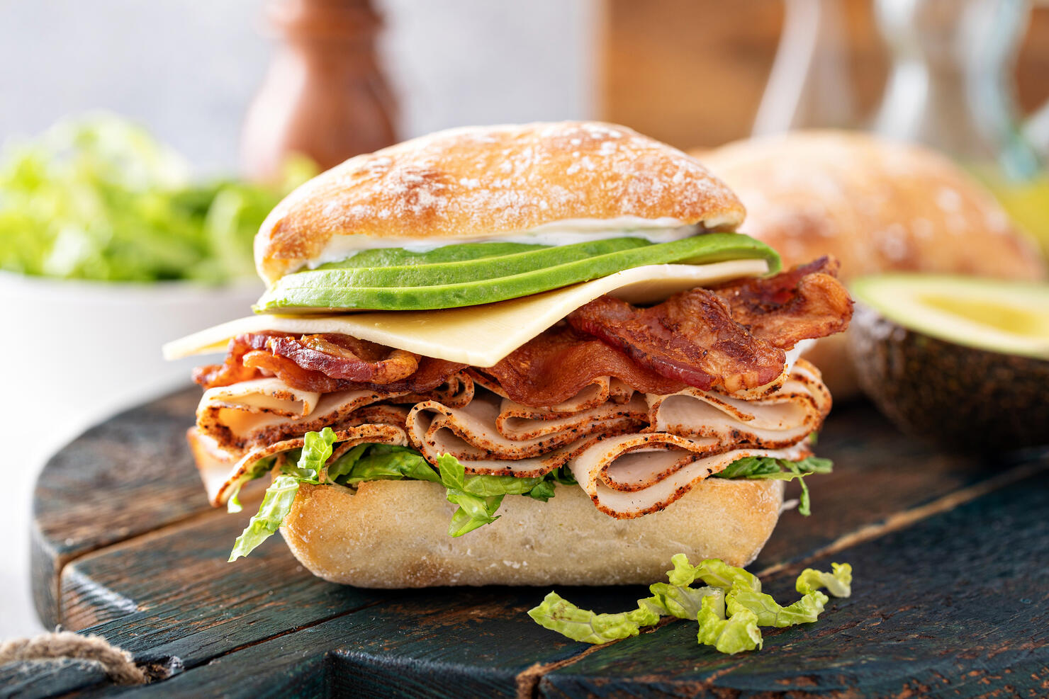 Fresh and healthy avocado turkey sandwich with swiss cheese