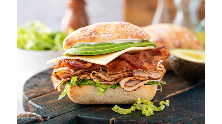 Fresh and healthy avocado turkey sandwich with swiss cheese