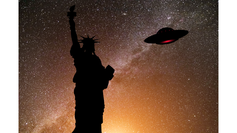 The Statue of Liberty and UFO in the starry sky. New York