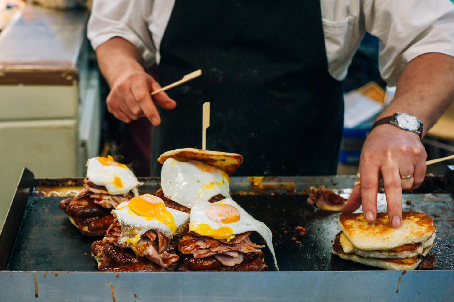 Cook preparing sandwiches on the griddle