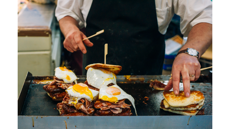 Cook preparing sandwiches on the griddle