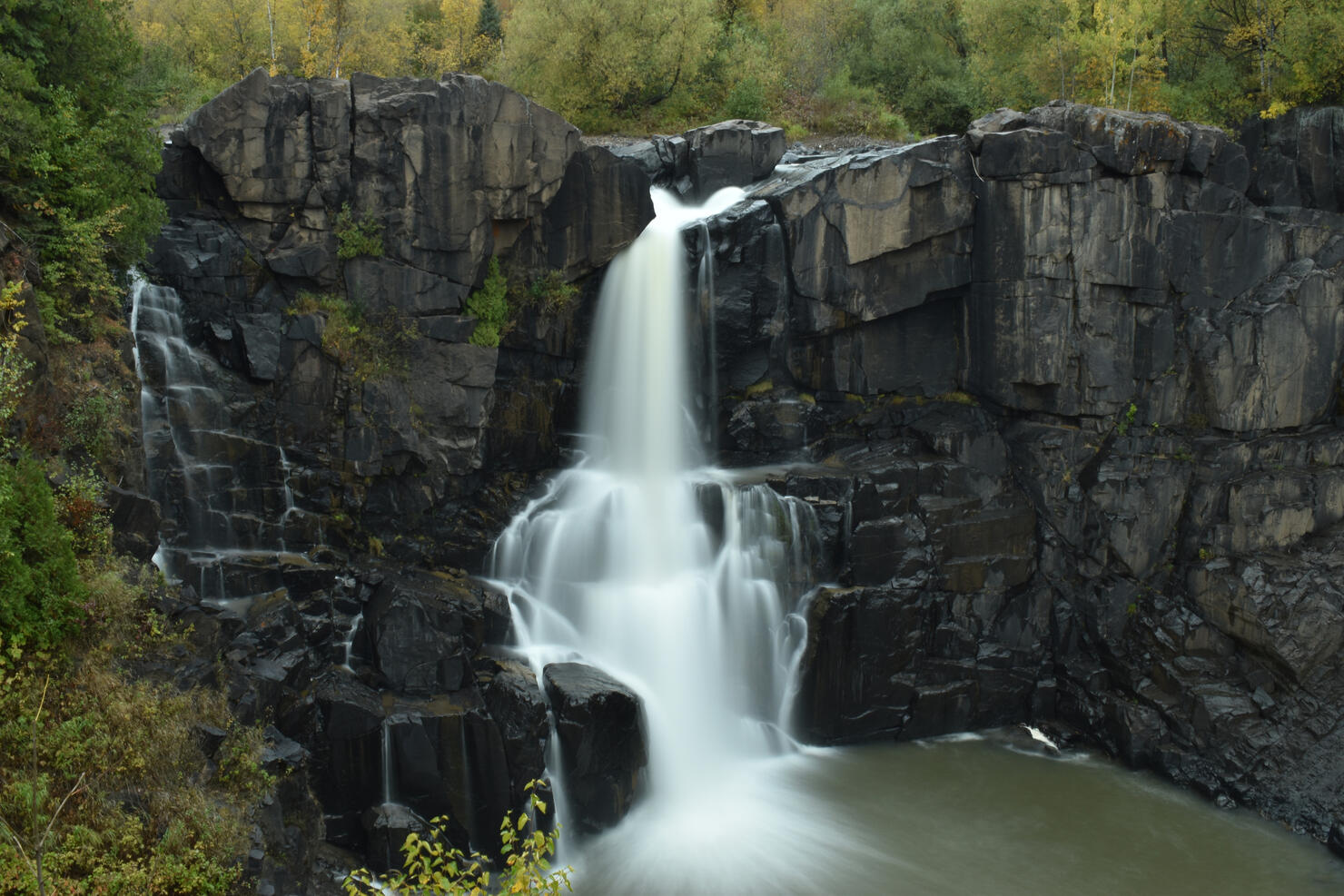 Scenic view of waterfall in forest,Grand Marais,Minnesota,United States,USA