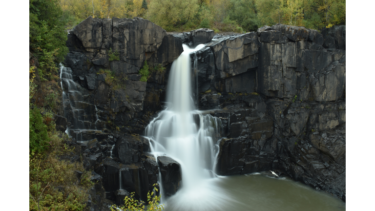 Scenic view of waterfall in forest,Grand Marais,Minnesota,United States,USA