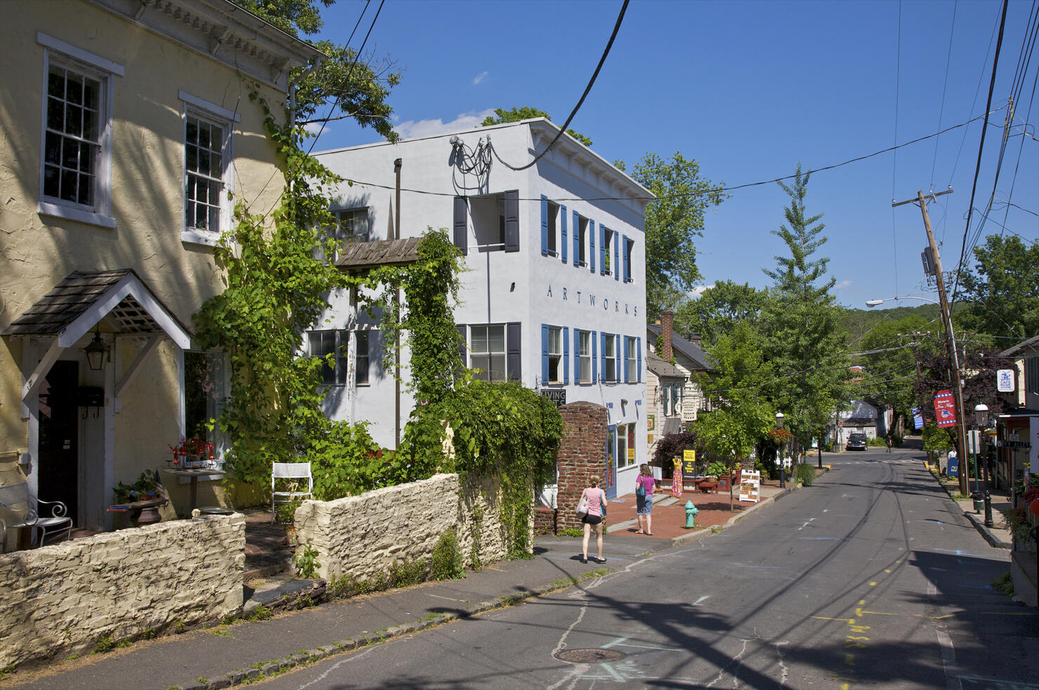 Street with people on sidewalk near nice buildings