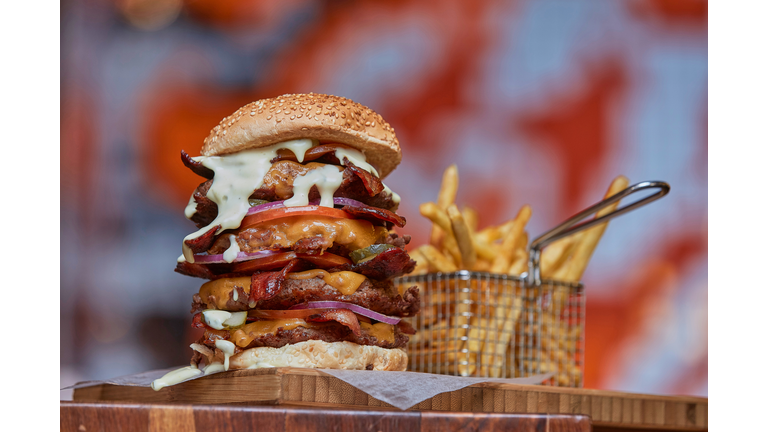 Close-up of giant burger and fries