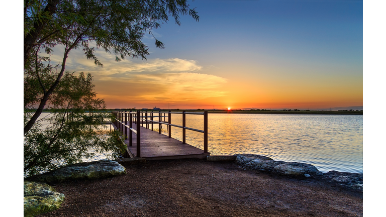 Pier on a small lake at sunset
