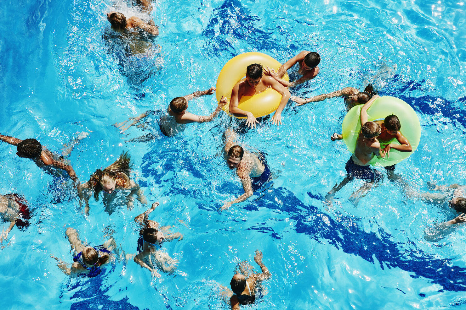 Group of kids playing together in outdoor pool