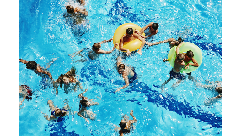 Group of kids playing together in outdoor pool