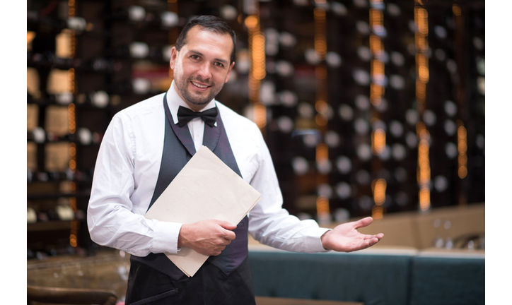 Waiter welcoming people to a restaurant