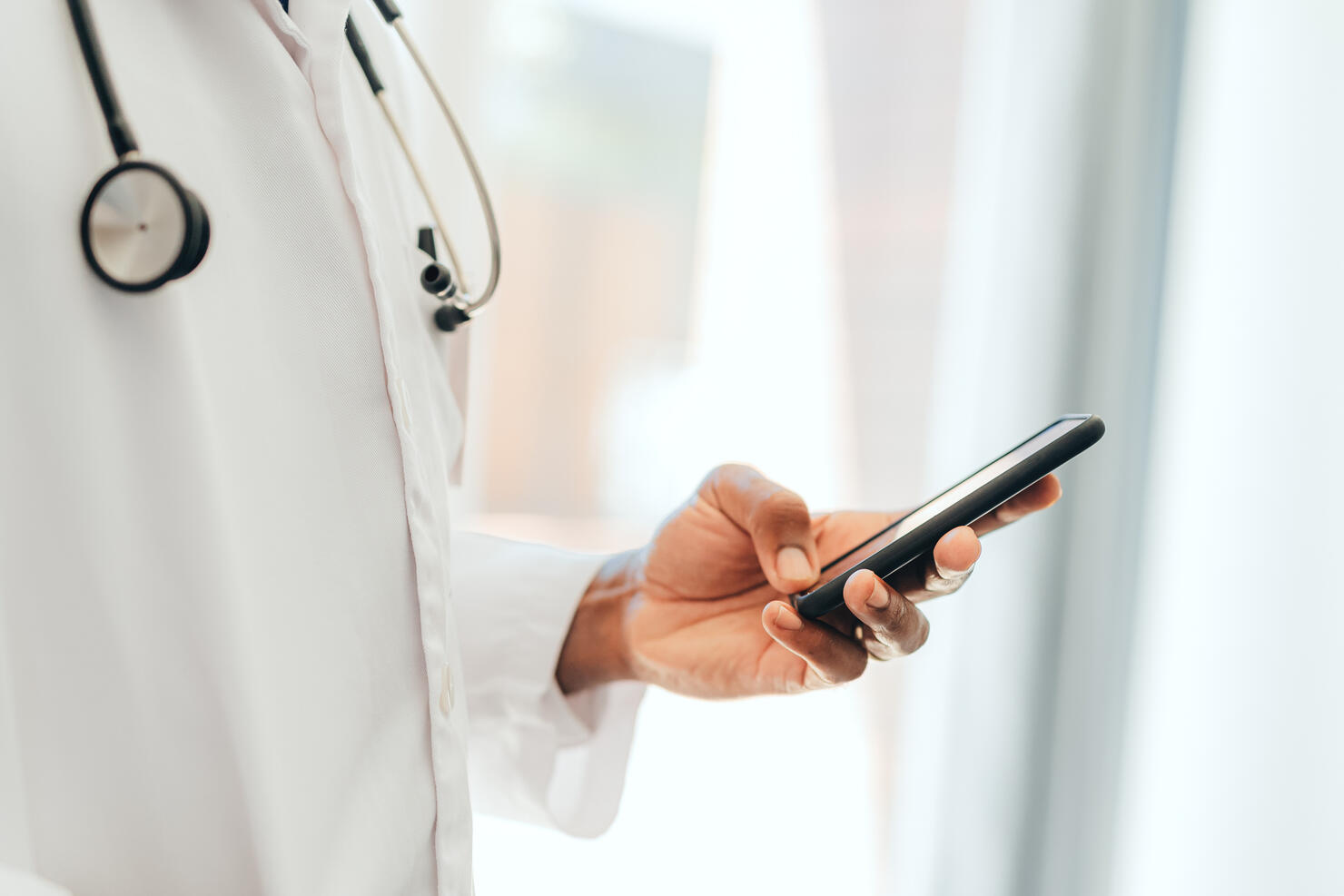 Hand of black healthcare doctor with phone, 5g mobile device or smartphone for calling or communication. African man or person on digital cellphone technology app reading online medical internet news