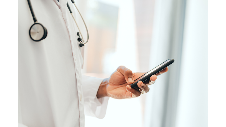 Hand of black healthcare doctor with phone, 5g mobile device or smartphone for calling or communication. African man or person on digital cellphone technology app reading online medical internet news