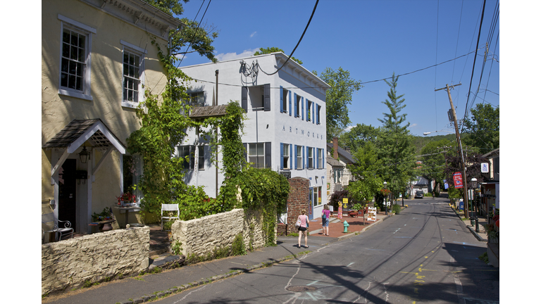 Street with people on sidewalk near nice buildings