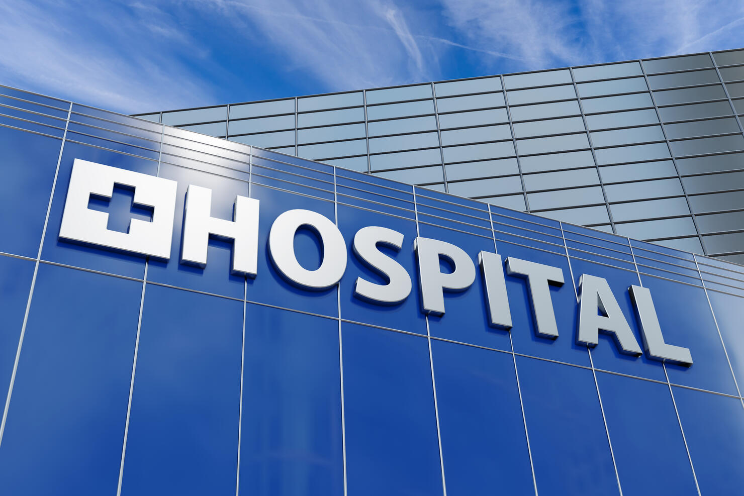 Building facade of a hospital in commercial and business district under blue sky