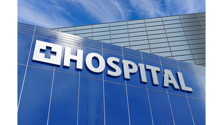 Building facade of a hospital in commercial and business district under blue sky